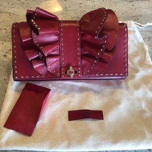 Valentino Garavani red bow clutch with gold strap